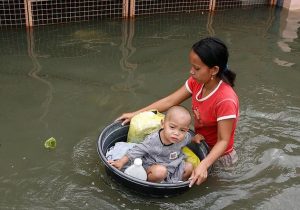 Philippines: A mother keeping her child safe using a basin during the onslaught of Typhoon Ketsana