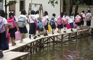 Philippines: Children crossing on a makeshift bridge to get to school