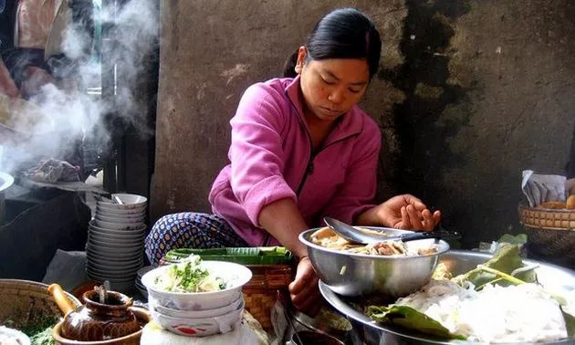 A Burmese woman is selling salads